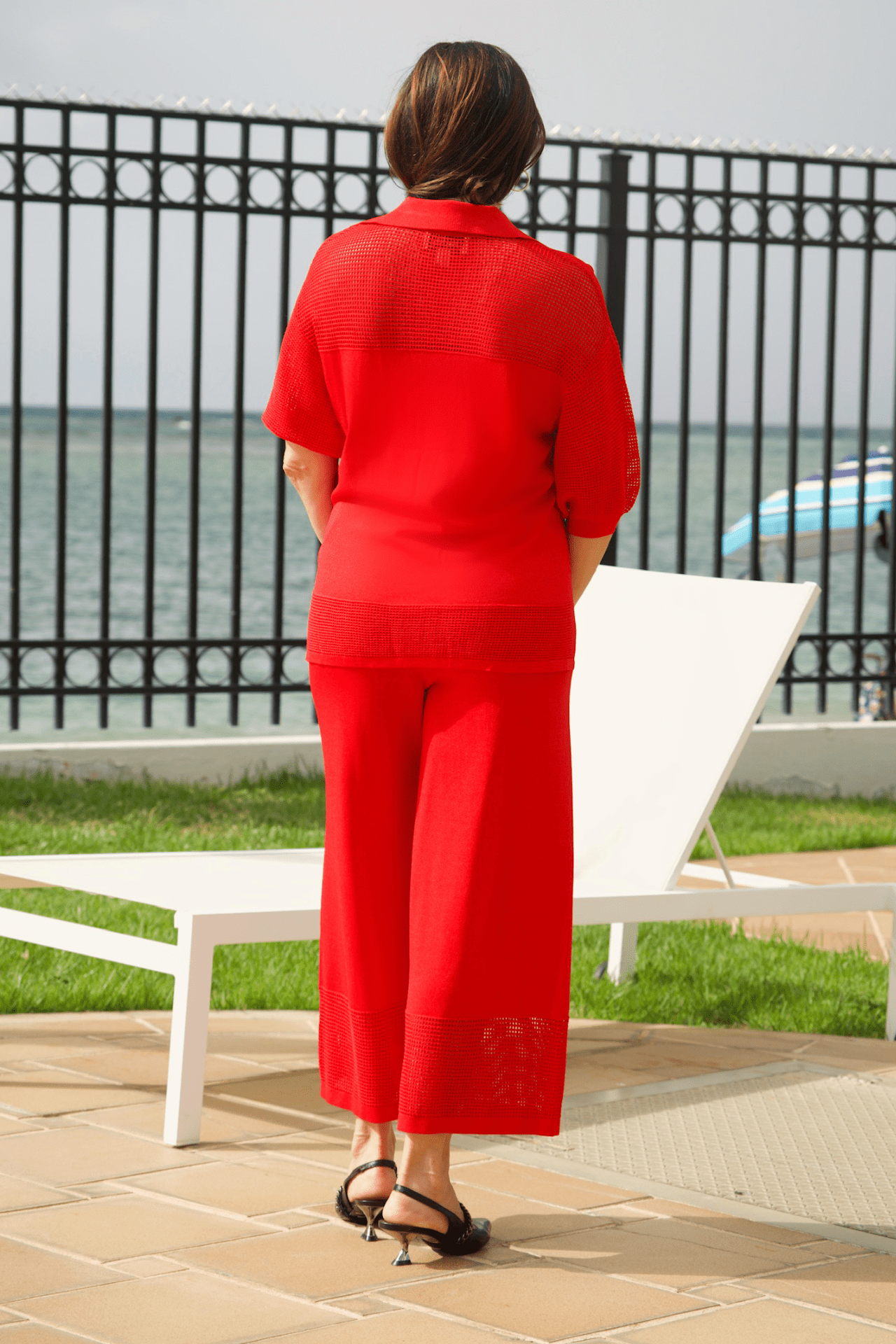 Back view of women's scarlet breeze perforated pant set, offering a modern and chic statement look.