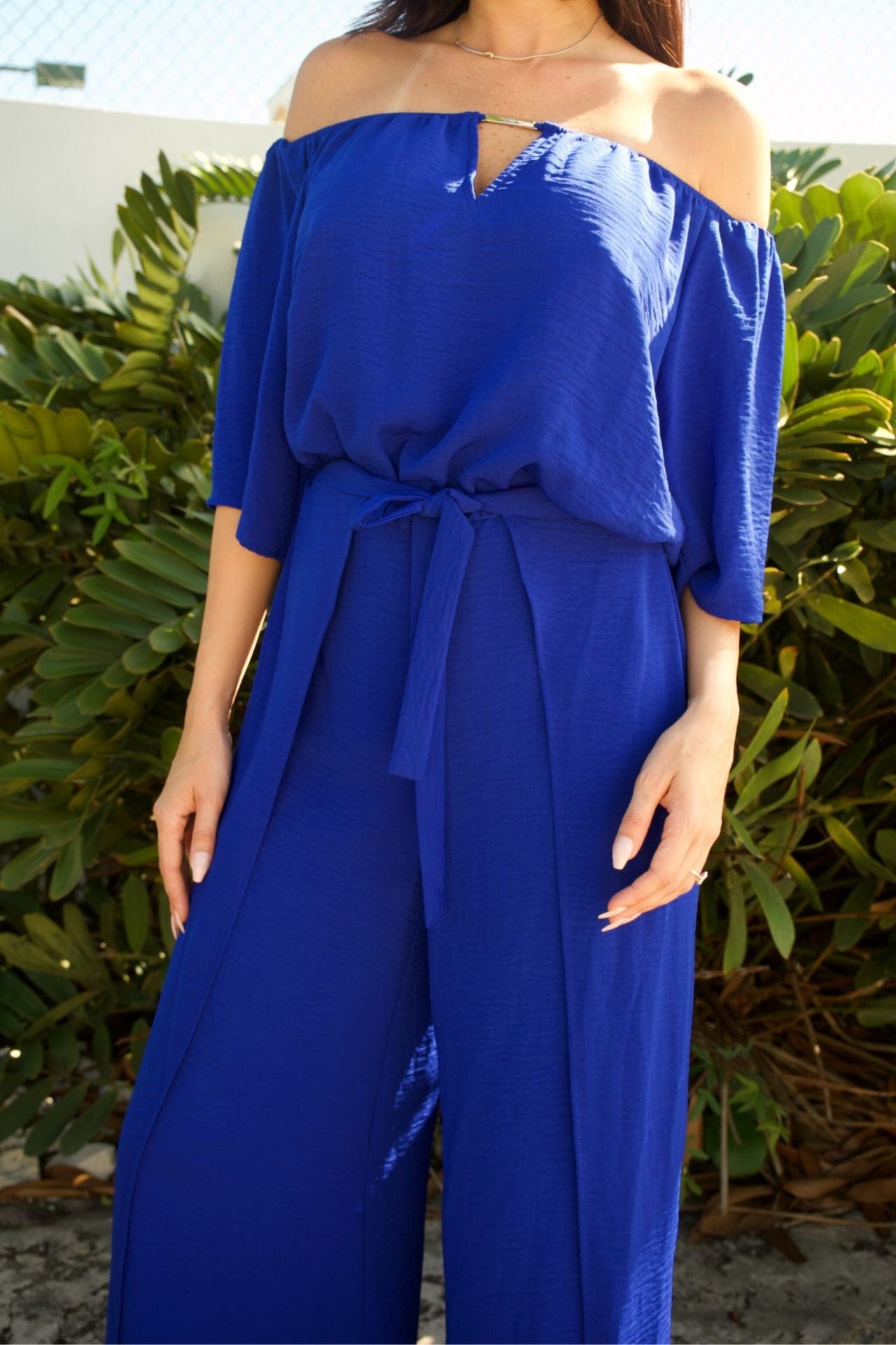 Close-up of off-shoulder neckline with metallic detail and relaxed sleeves.