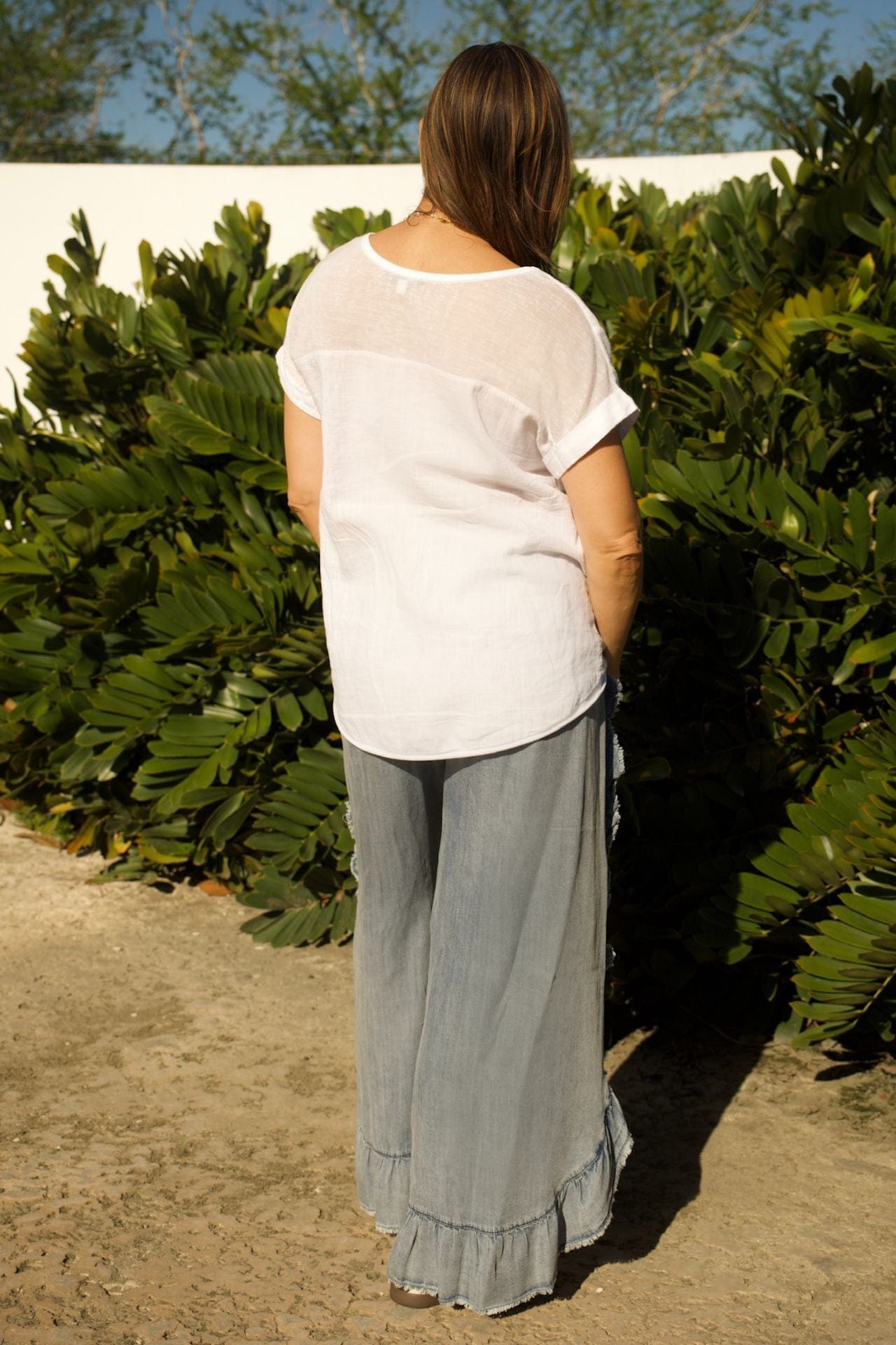 Back view of denim ruffle pants and flowy linen tee set