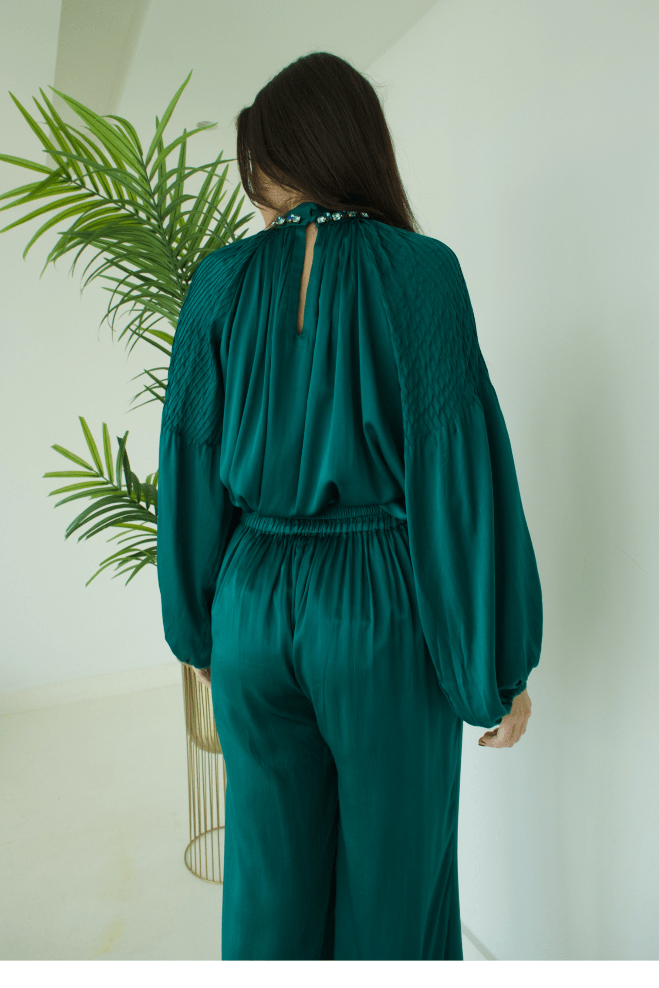 Back view of the Women's Green Satin High Neck Top with Blue Stone Details and Pant Set showcasing a sleek silhouette and refined tailoring.