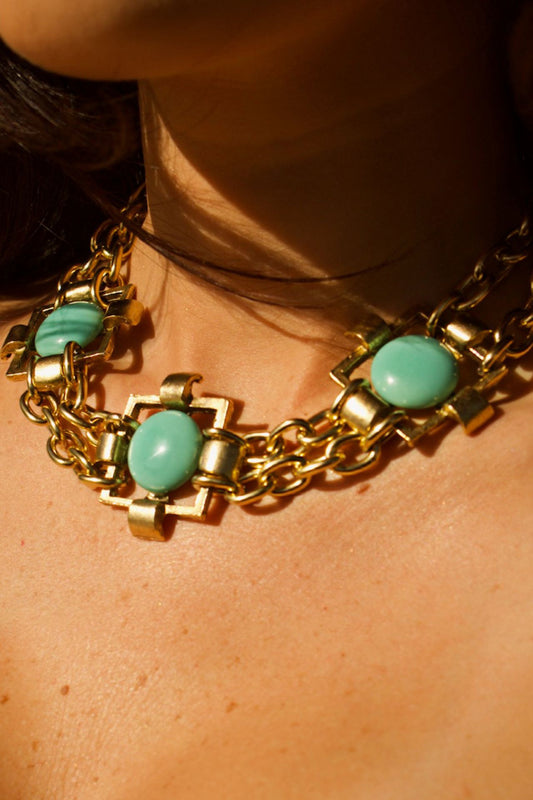 Gold brass choker with turquoise stones on white background, handmade and 22k gold-coated

