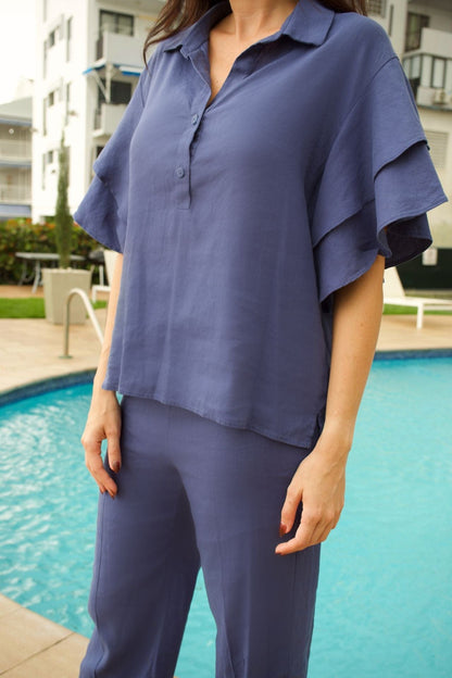 Detailed close-up of flounce sleeve and linen texture, showcasing premium craftsmanship.