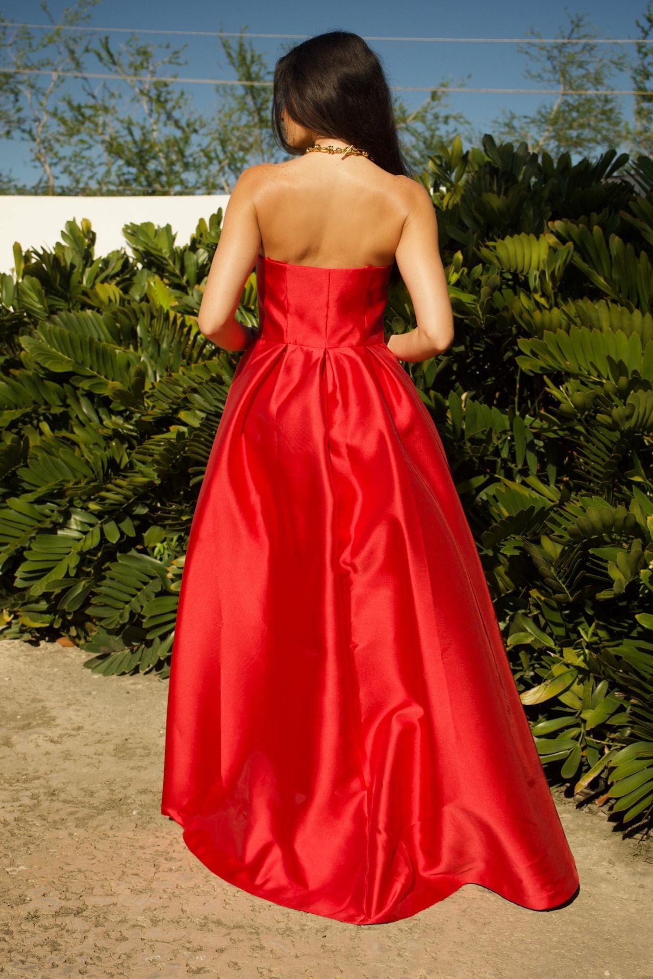 Close-up of red taffeta fabric and structured strapless bodice
