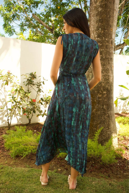 Back view of sleeveless maxi dress with tie waist and flowing hem.