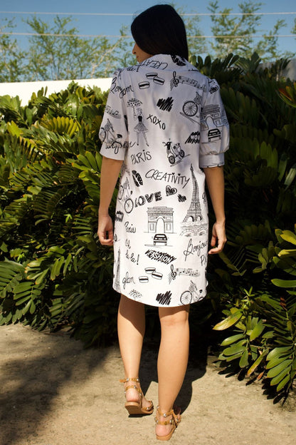 Back view of white dress showing flowy fit and sleeve detail.