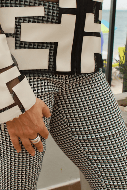 Detailed view of faux leather accents on a women's black mesh jacket, highlighting its sophisticated design.