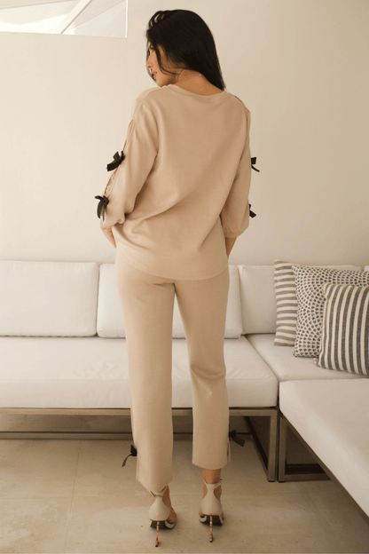 Back view of women's long sleeve pant set with ribbon details, showcasing a modern and stylish silhouette.