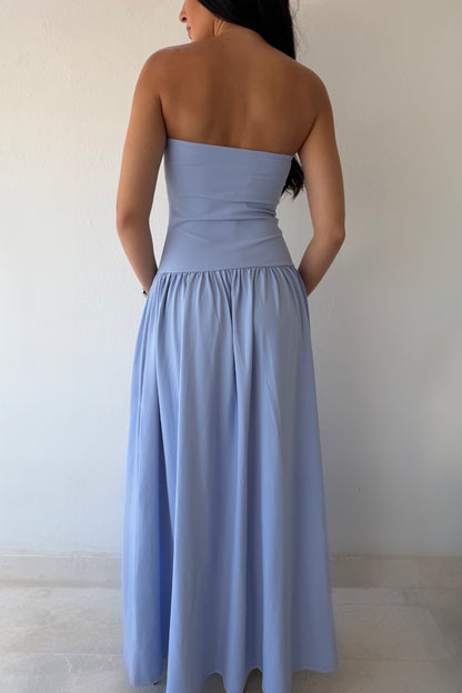 Model wearing the Blue Horizon Maxi Dress in soft sky blue featuring a strapless fitted bodice and flowing maxi skirt.