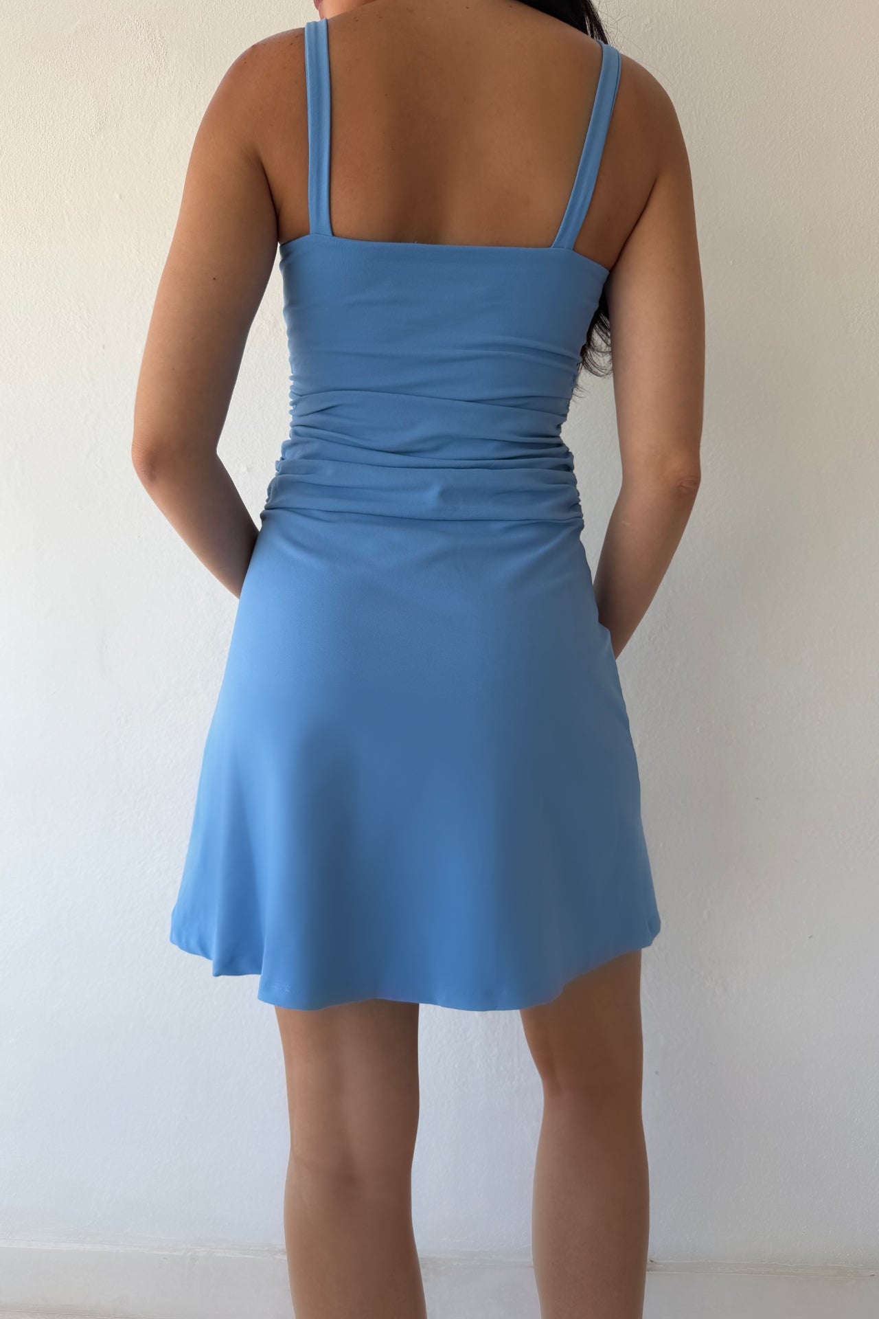 Model wearing the Bluebell Ruched Day Dress featuring a square neckline, ruched waist detail, and flattering A-line silhouette in soft blue.