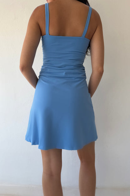 Model wearing the Bluebell Ruched Day Dress featuring a square neckline, ruched waist detail, and flattering A-line silhouette in soft blue.