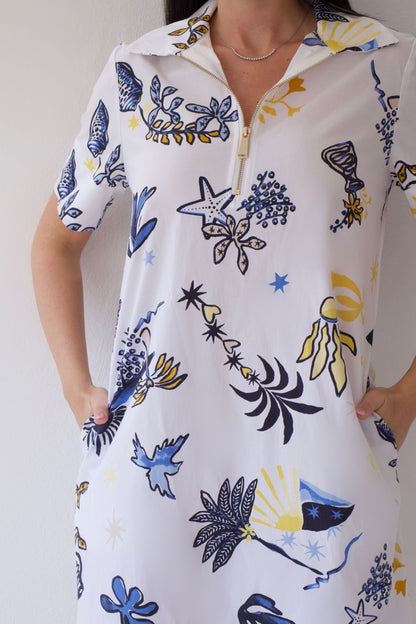 White dress with coastal sketch pattern worn by a person against a plain background