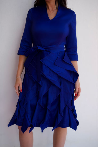 Royal blue taffeta dress with waist tie and ruffle skirt, styled for an elegant cocktail or special occasion look front view.