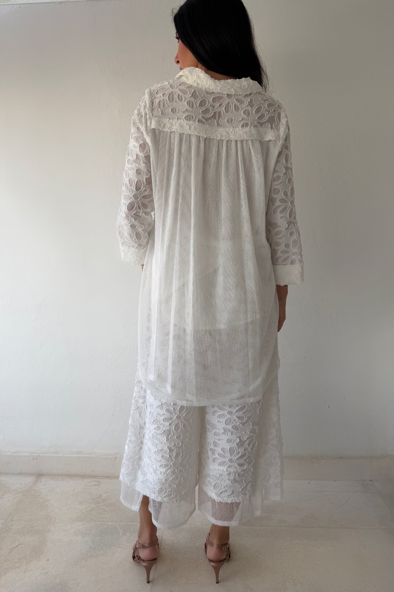 Model wearing the Ivory Garden Texture Set featuring a textured floral zip-front jacket and matching wide-leg pants in ivory.
