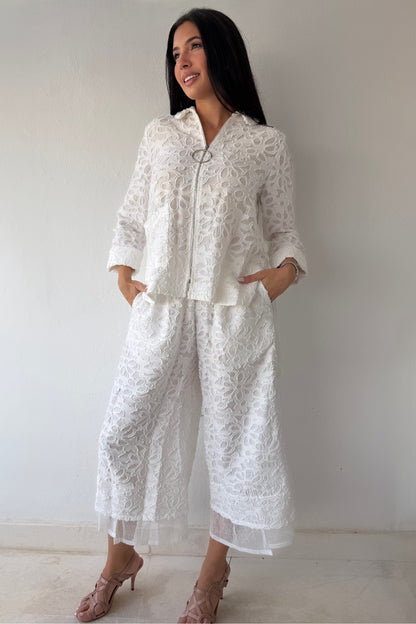 Model wearing the Ivory Garden Texture Set featuring a textured floral zip-front jacket and matching wide-leg pants in ivory.