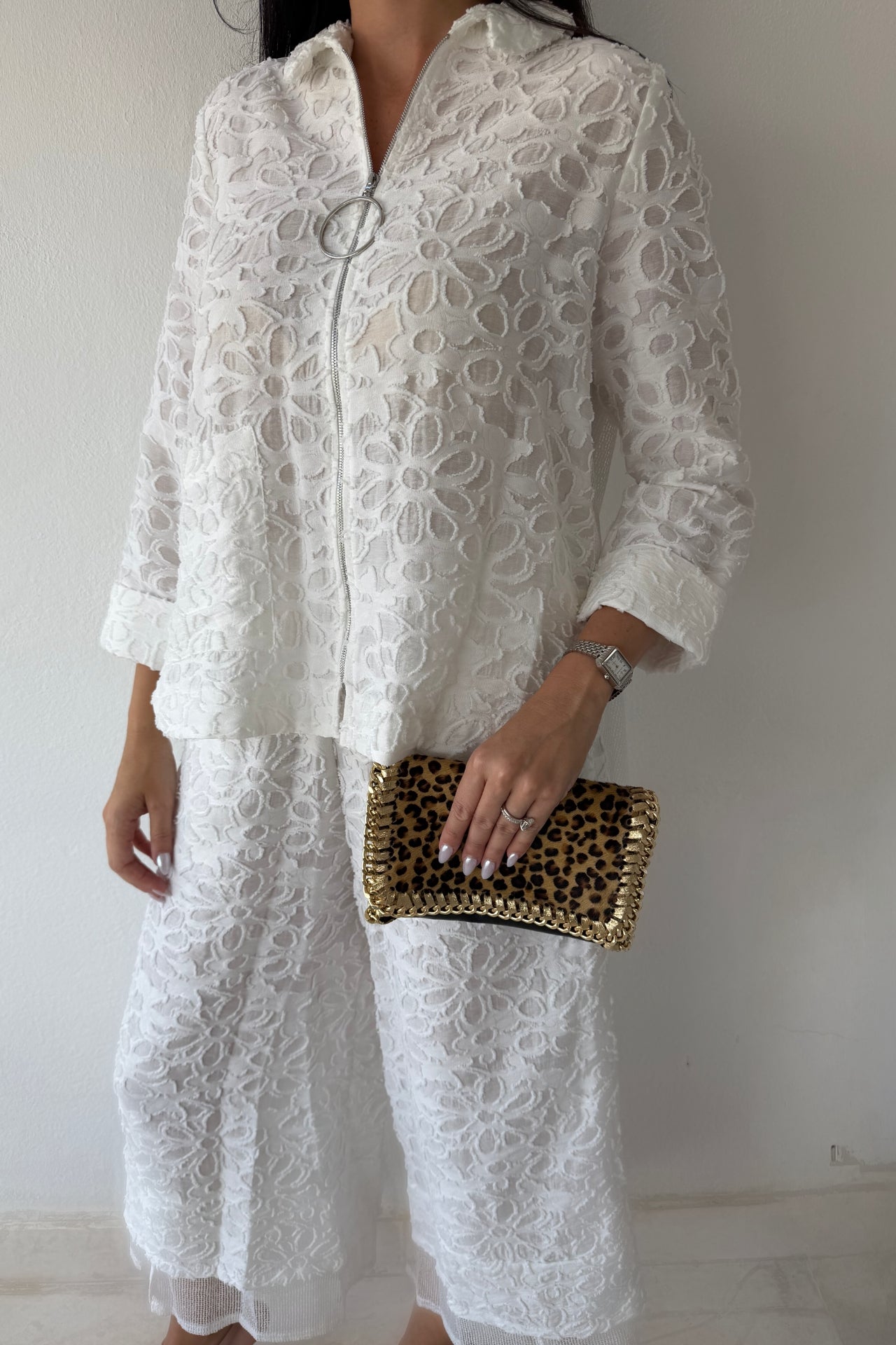 Model wearing the Ivory Garden Texture Set featuring a textured floral zip-front jacket and matching wide-leg pants in ivory.