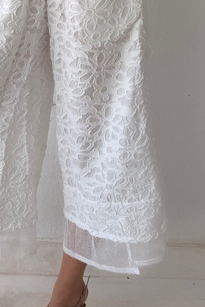 Model wearing the Ivory Garden Texture Set featuring a textured floral zip-front jacket and matching wide-leg pants in ivory.