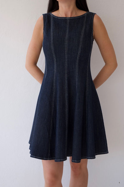 Dark denim dress worn by a person on a plain background