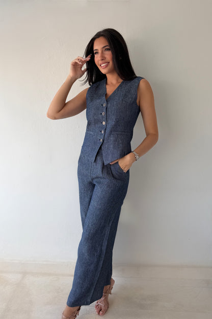 Model wearing the Midnight Tailored Vest in navy linen featuring a sleeveless tailored silhouette, front button closure, and adjustable back buckle detail.