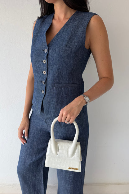 Model wearing the Midnight Tailored Vest in navy linen featuring a sleeveless tailored silhouette, front button closure, and adjustable back buckle detail.