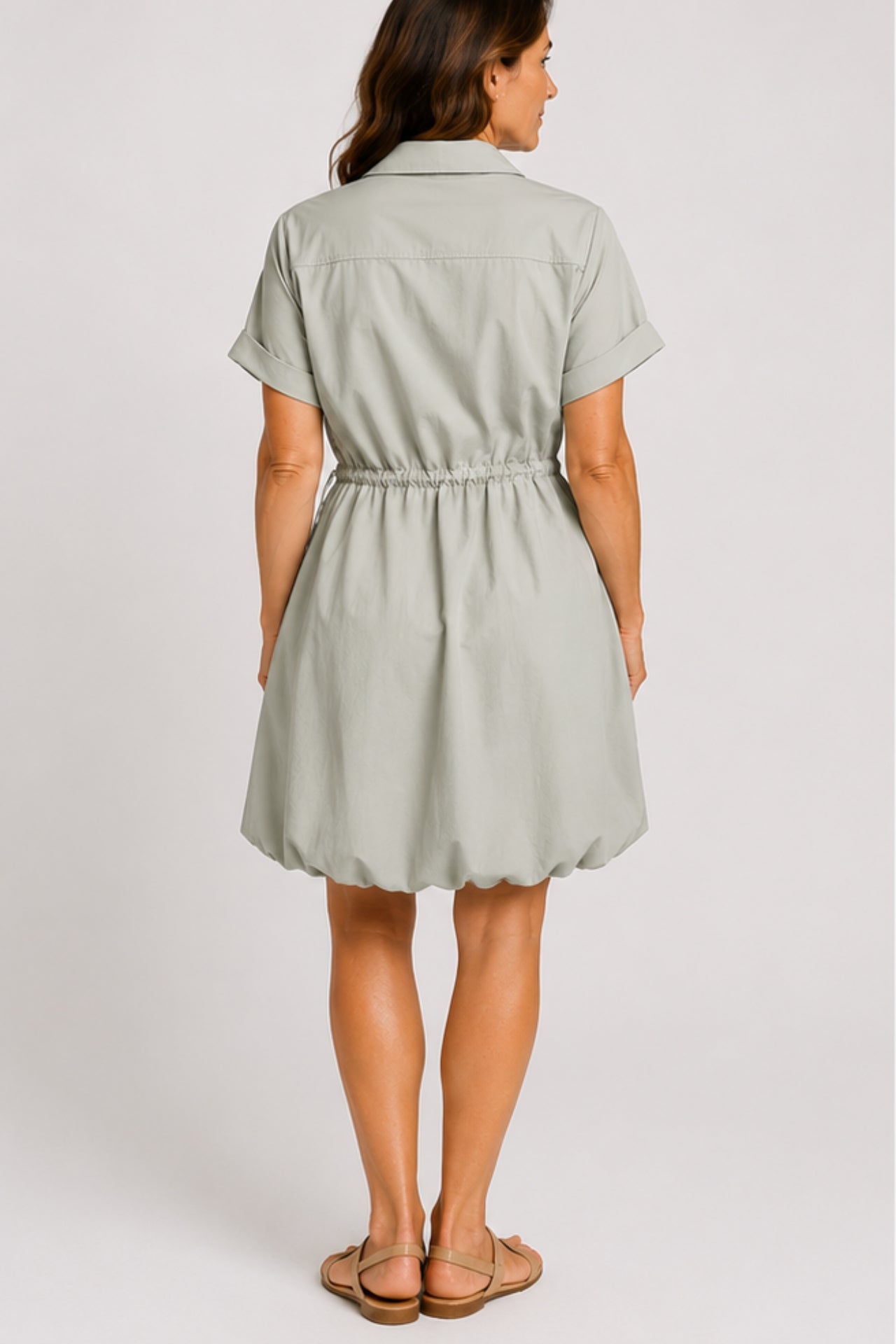 Mineral gray cinched shirt dress with button-front design, adjustable waist, roll-tab sleeves, and side pockets styled for elegant everyday wear.