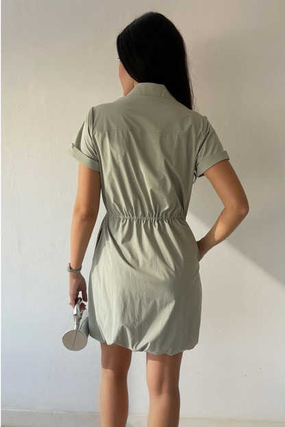 Mineral gray cinched shirt dress with button-front design, adjustable waist, roll-tab sleeves, and side pockets styled for elegant everyday wear.