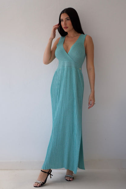 Woman wearing a mint dress against a plain background