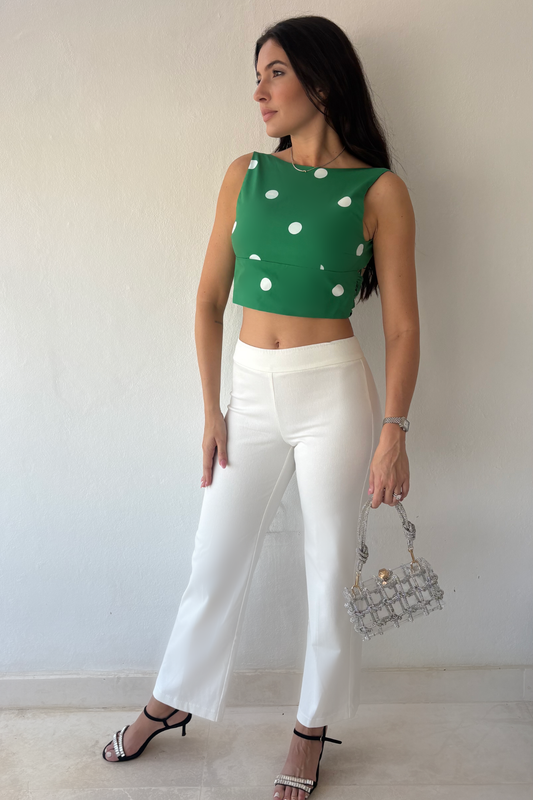 Monaco Polka Top in green and white styled with white trousers, front view