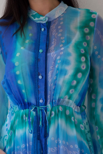 Blue and green patterned dress with a close-up on the chest area.