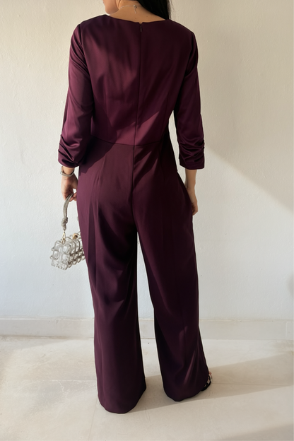 Back view of the Plum Elegance Jumpsuit featuring three-quarter sleeves, fitted waist, back zipper and wide-leg silhouette.