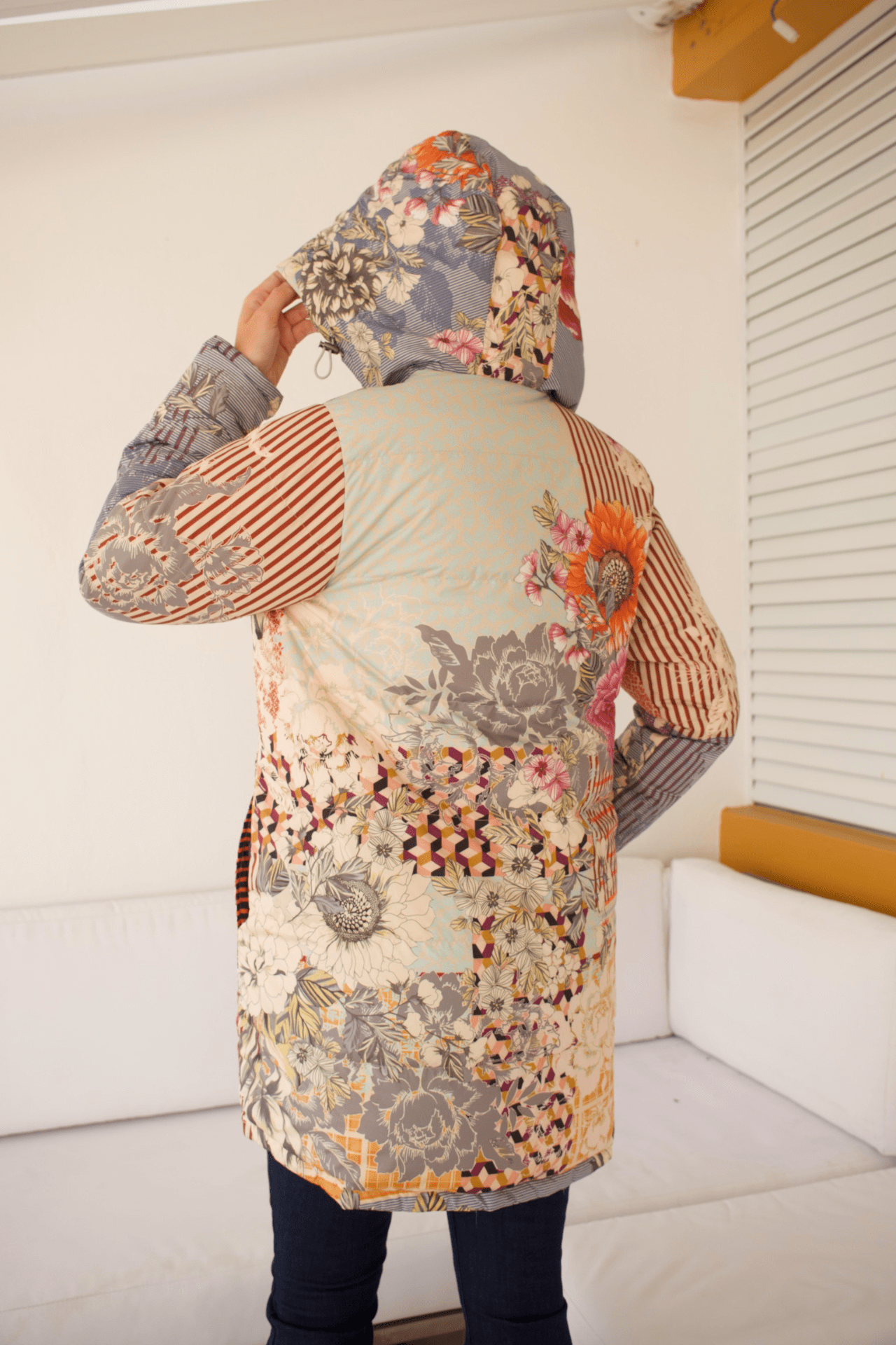 Back view of the Reversible Down Parka Jacket featuring a charming floral pattern for a stylish and feminine look.