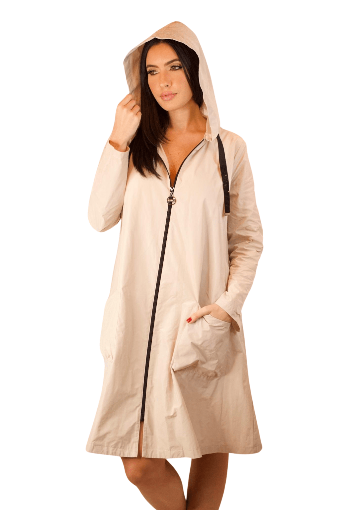 A woman wearing a beige long sleeve raincoat with a black zipper and a hoodie.