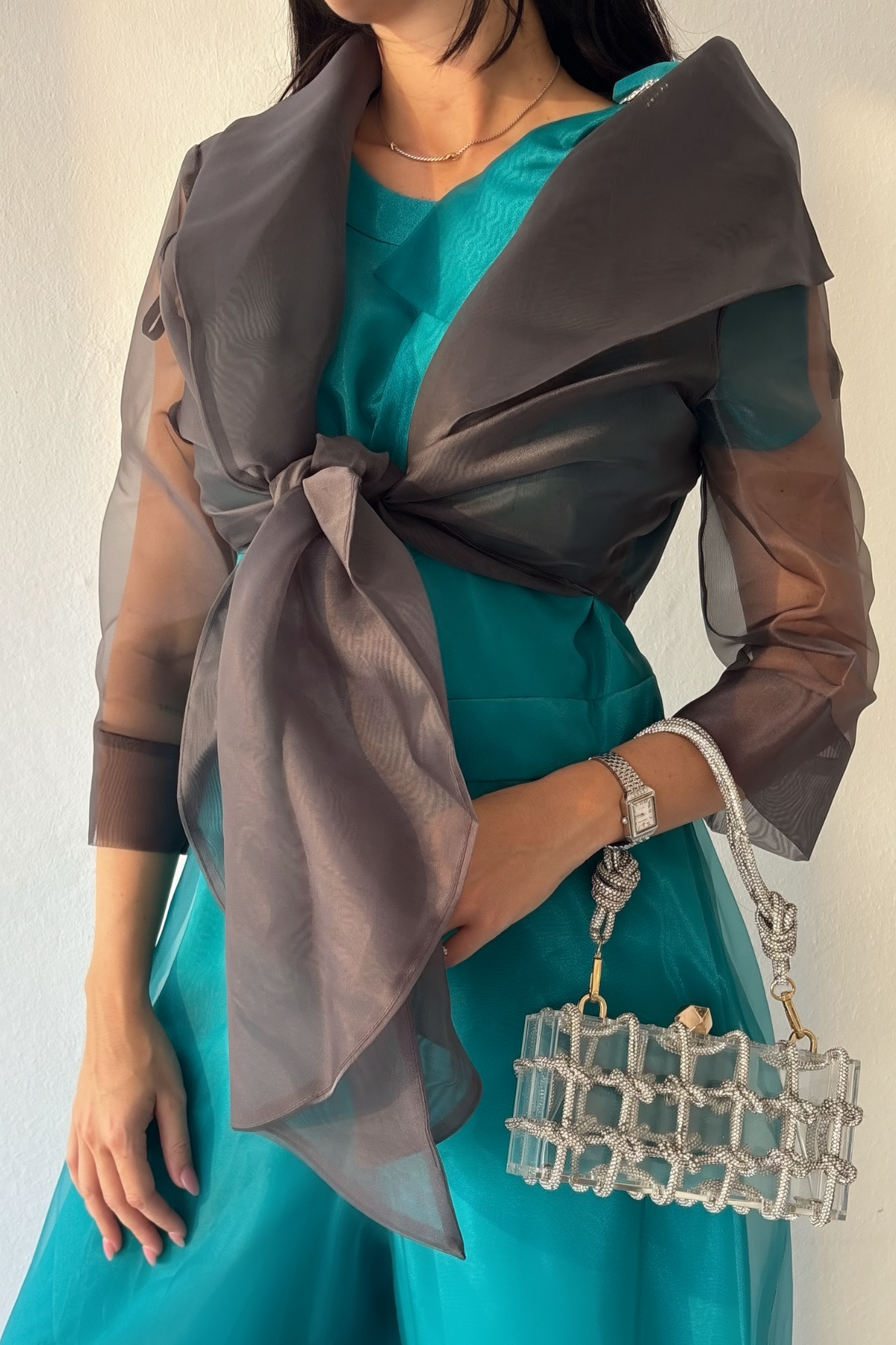 Sheer charcoal organza wrap with tie front and three-quarter sleeves styled over teal jumpsuit