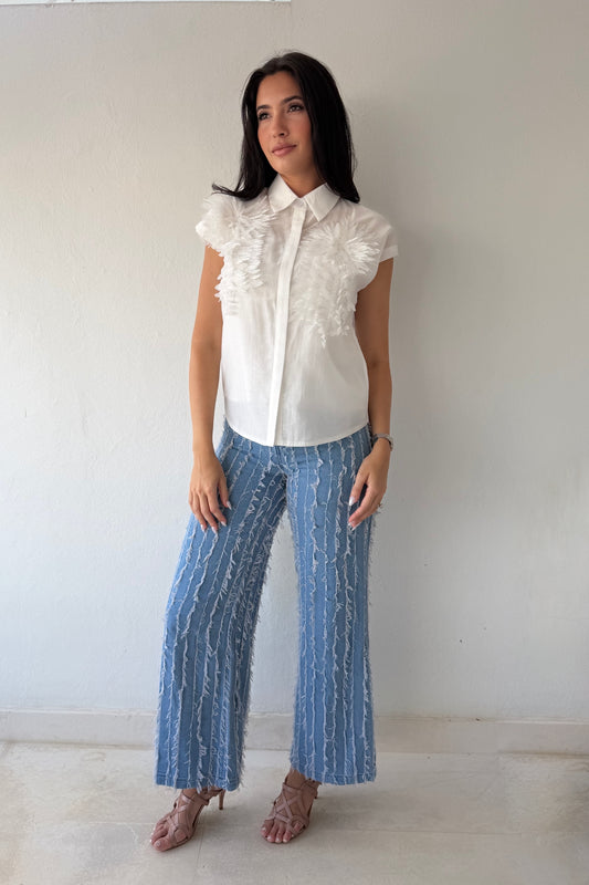 Model wearing the White Blossom Statement Blouse featuring three-dimensional floral appliqué details, short sleeves, and a coordinating camisole.
