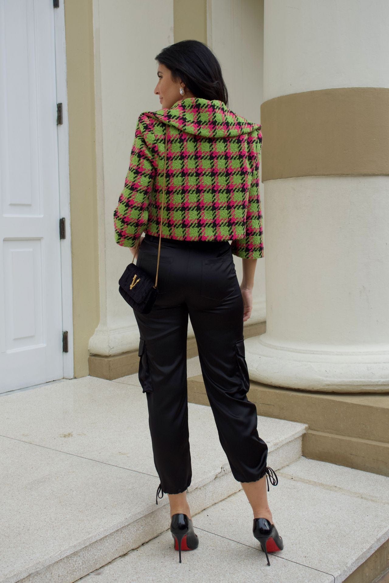 Close-up of apple green and magenta houndstooth cropped jacket with crystal buttons and wide collar.
