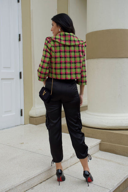 Close-up of apple green and magenta houndstooth cropped jacket with crystal buttons and wide collar.