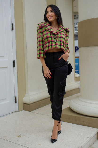 Close-up of apple green and magenta houndstooth cropped jacket with crystal buttons and wide collar.
