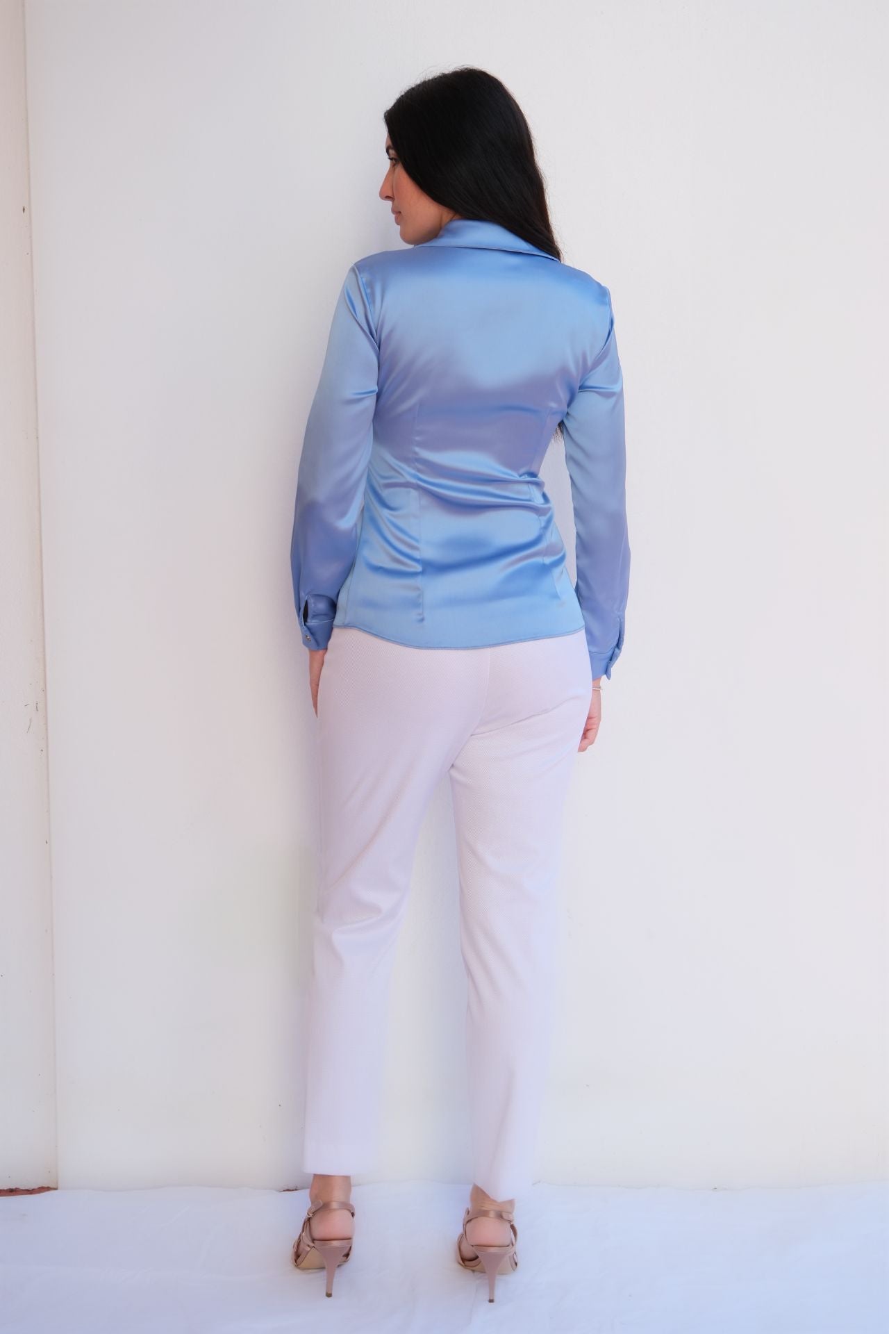 Baby blue satin ruched front blouse styled with white trousers, elegant day to night women’s outfit