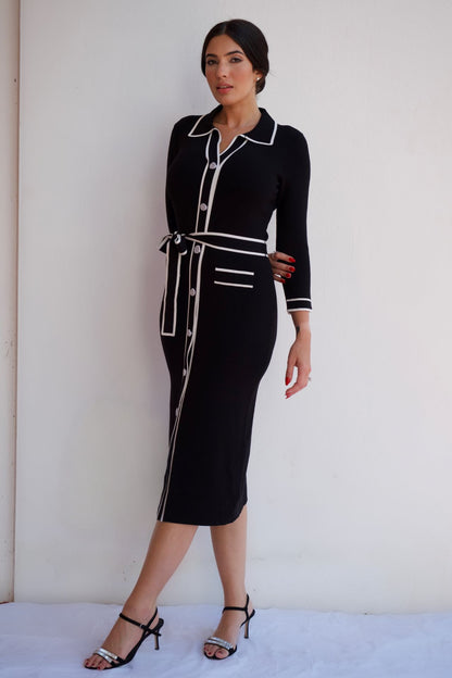 Black midi shirt dress with white contrast trim, button front, and waist tie, styled for an elegant day-to-night look