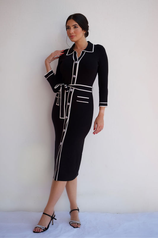 Black midi shirt dress with white contrast trim, button front, and waist tie, styled for an elegant day-to-night look