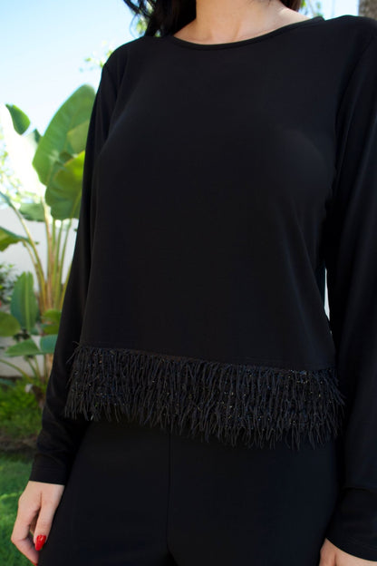 Model wearing black jersey fringe top and pant set with long sleeves — chic matching set Elegance Boutique