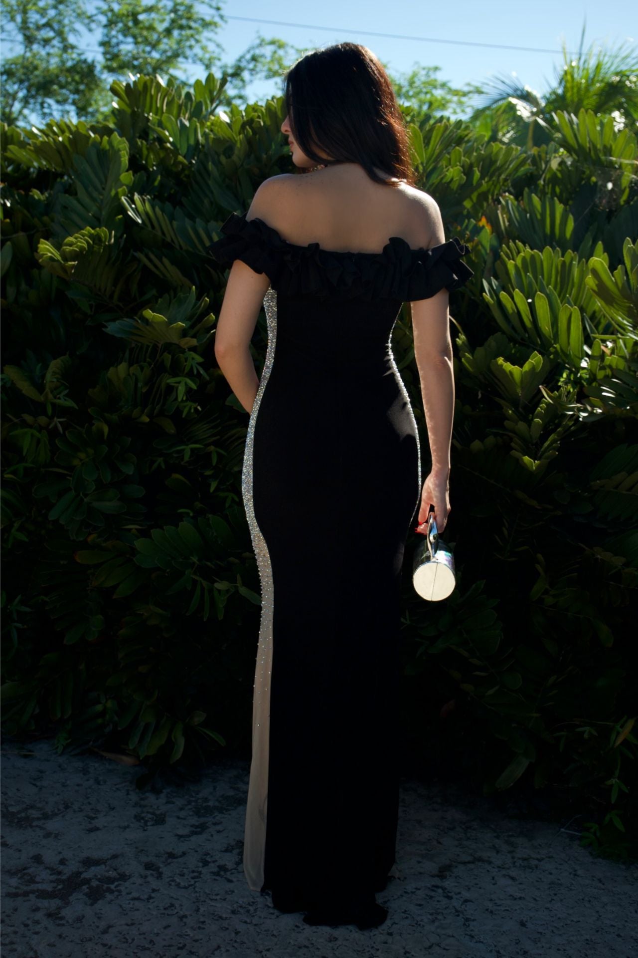 Model wearing black off-shoulder ruffle gown with beaded side panels — formal evening wear Elegance Boutique