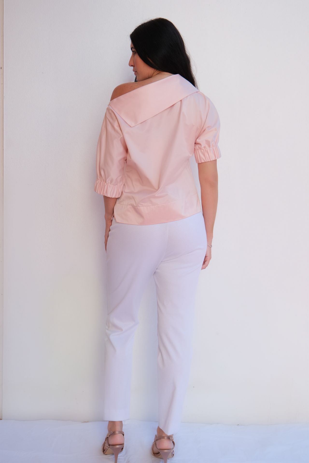 Soft pink satin blouse with relaxed fit and elastic sleeves styled for chic casual elegance