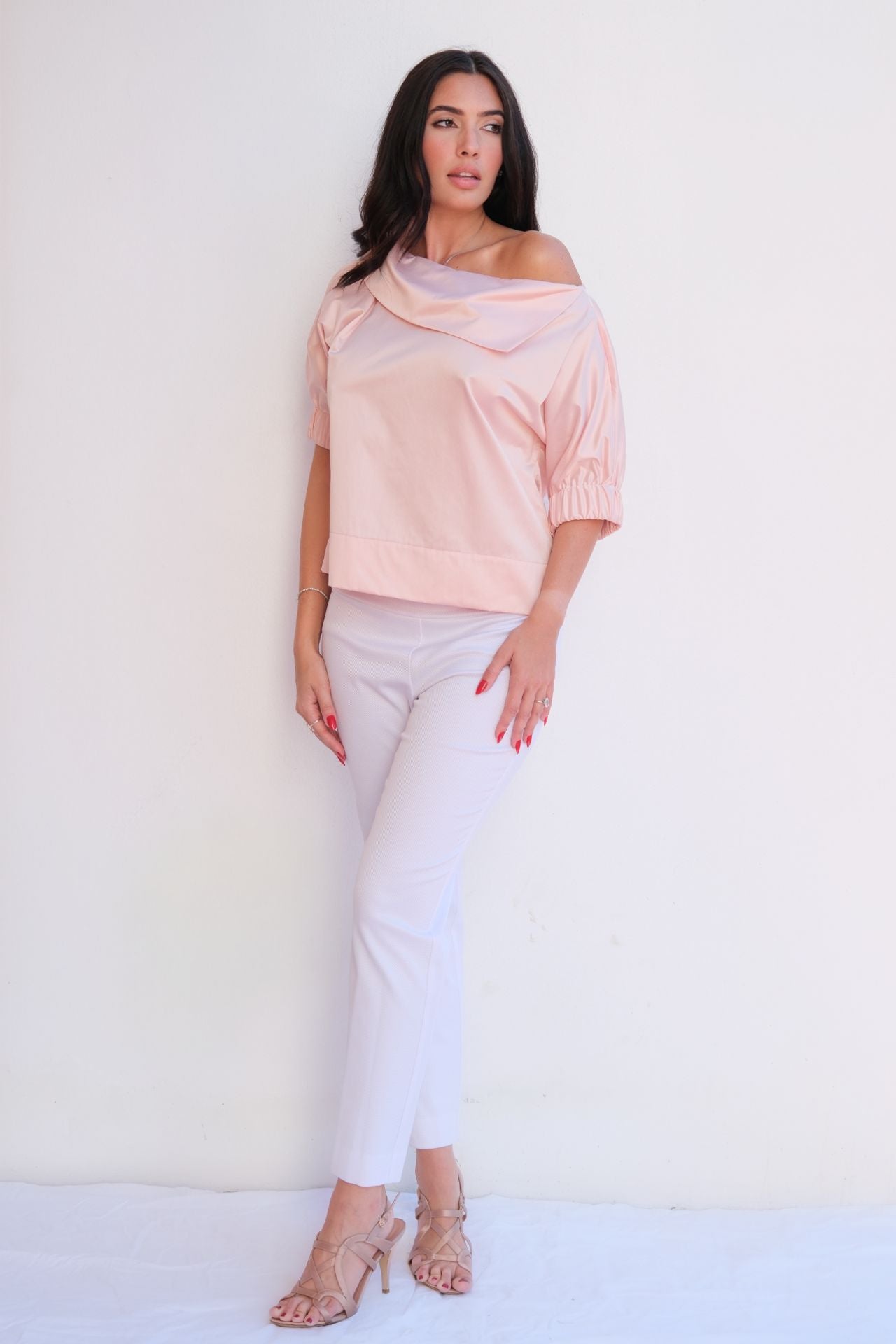 Soft pink satin blouse with relaxed fit and elastic sleeves styled for chic casual elegance