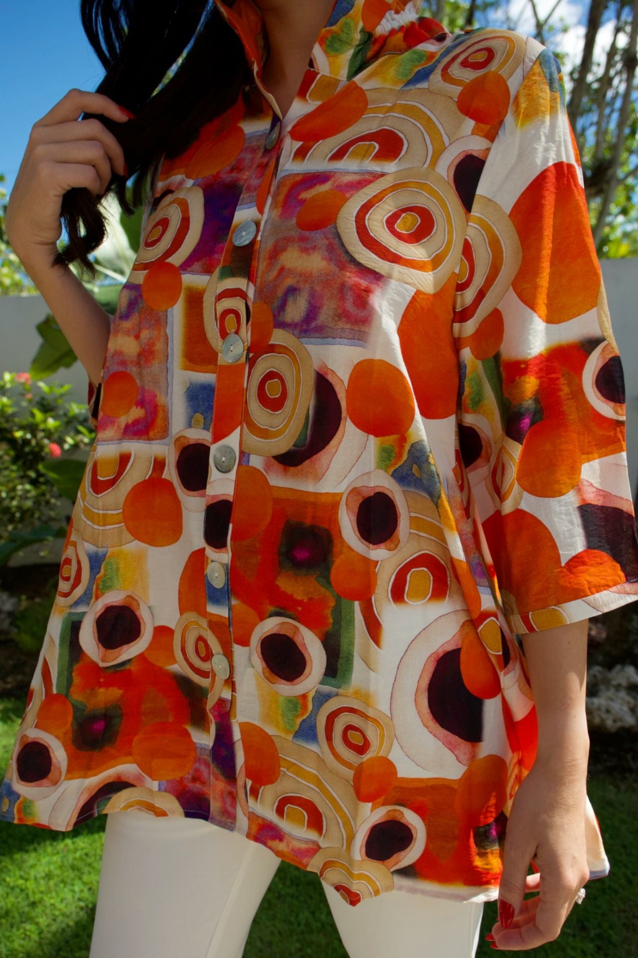 Bold multicolor circle-print tunic with button-down front — vibrant artistic top Elegance Boutique