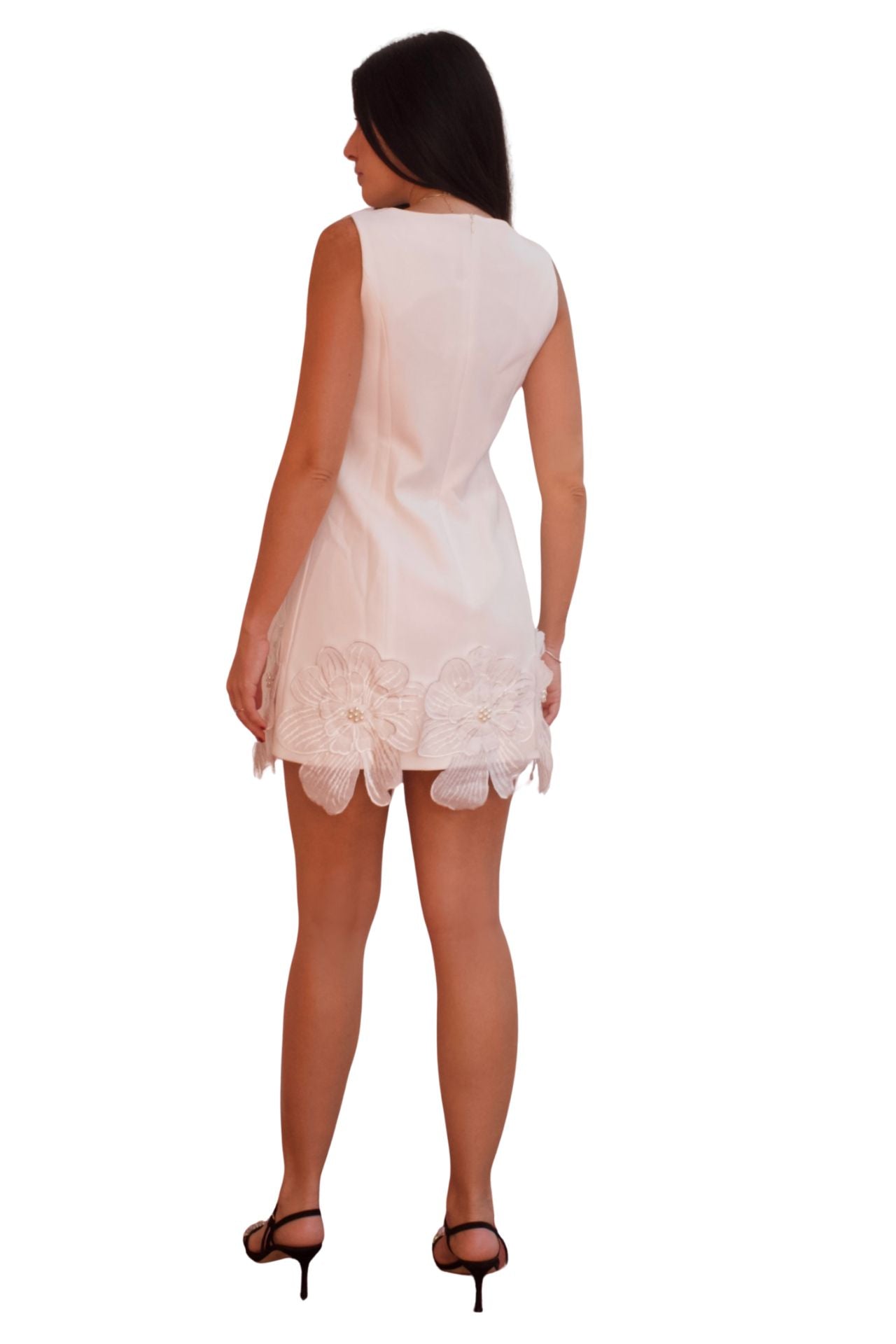 White cocktail dress with 3D floral appliqué and scalloped hem, elegant sleeveless mini dress for special occasions.