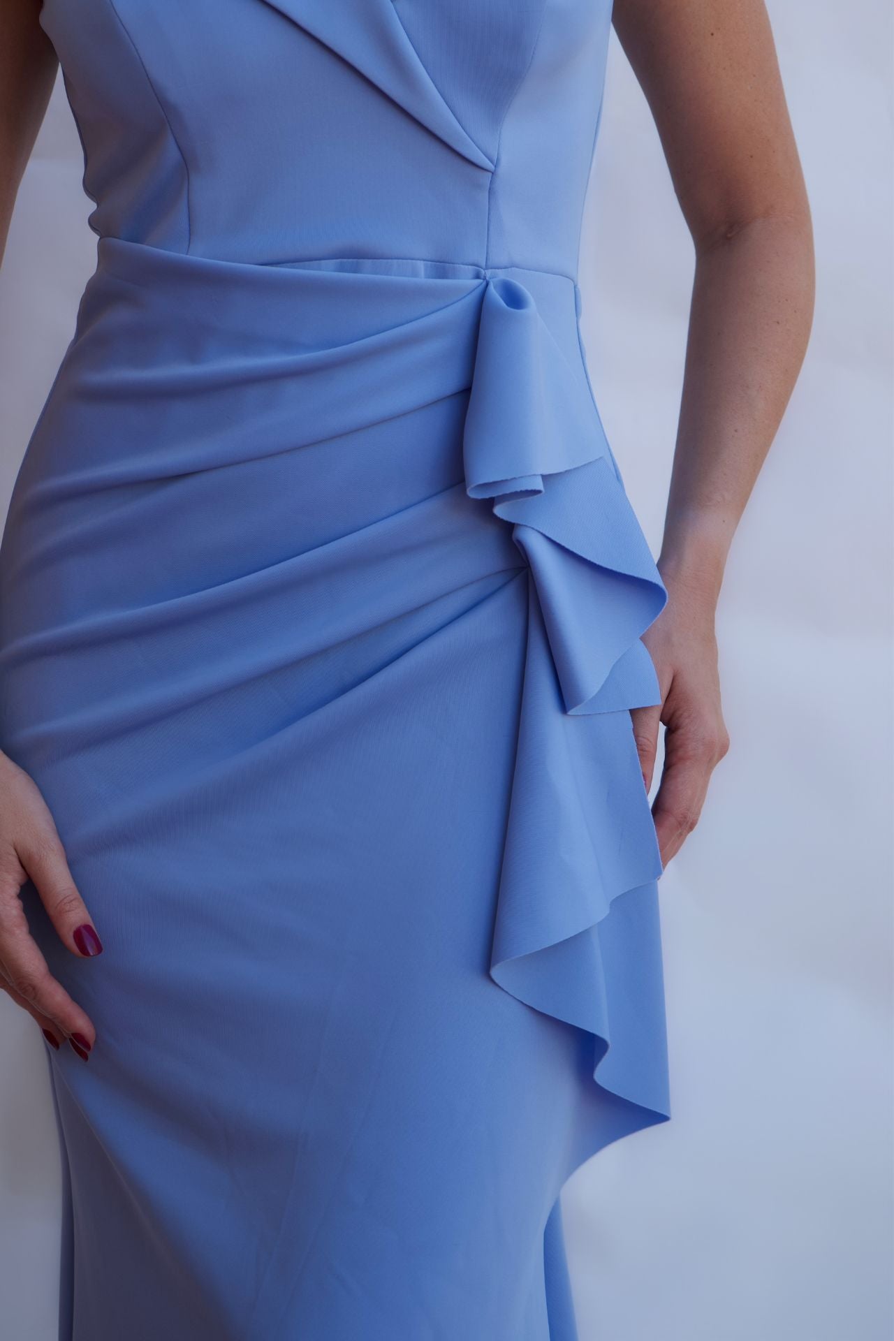 Celestial blue off-shoulder draped evening gown with fitted silhouette and floor length hem available online and in-store at Elegance Boutique