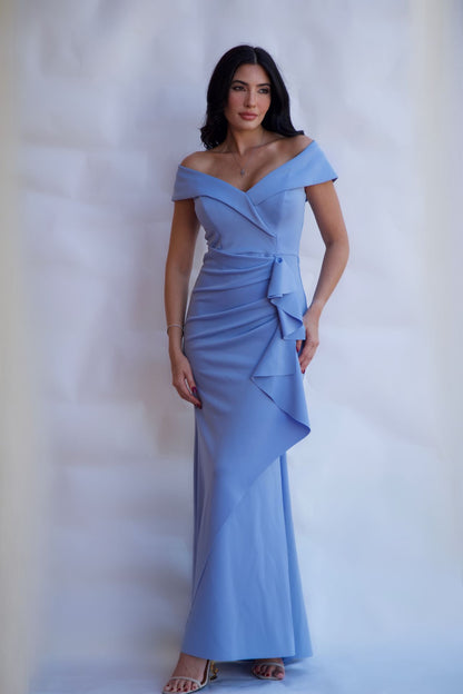 Celestial blue off-shoulder draped evening gown with fitted silhouette and floor length hem available online and in-store at Elegance Boutique
