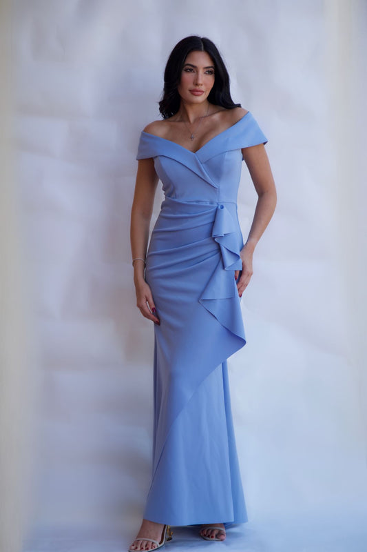 Celestial blue off-shoulder draped evening gown with fitted silhouette and floor length hem available online and in-store at Elegance Boutique