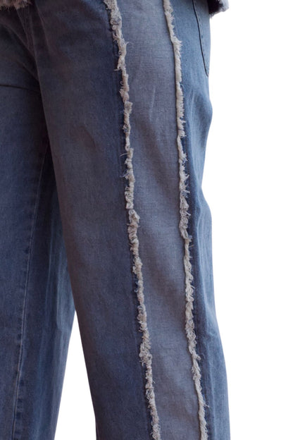 Woman wearing a two-piece denim set with frayed hem shirt and wide-leg cropped pants.