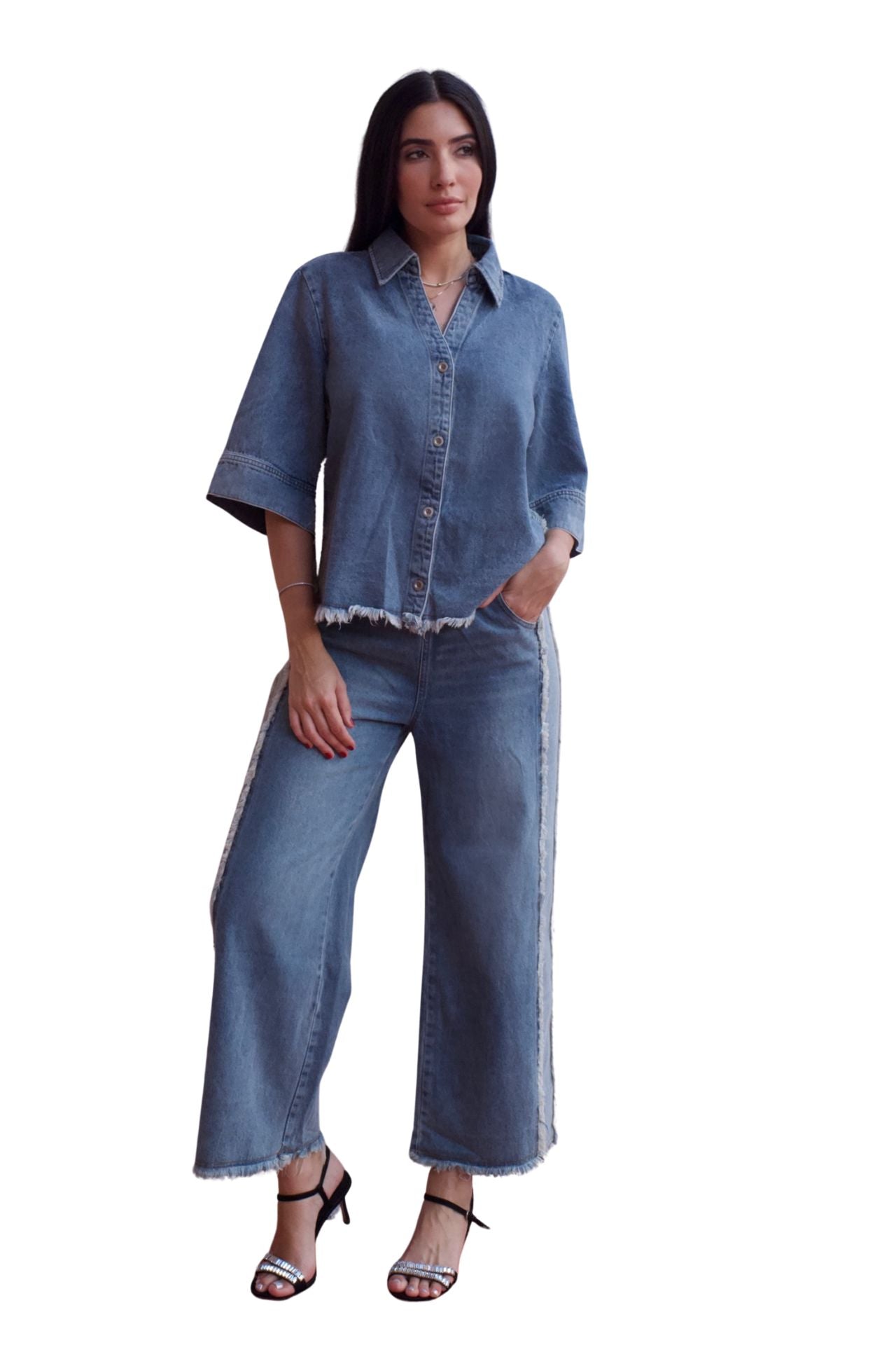 Woman wearing a two-piece denim set with frayed hem shirt and wide-leg cropped pants.